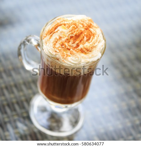 Irish coffee in an outdoor bar. Concept of St Patrick holiday. Holiday background. Irish national day. Warm tone. Square