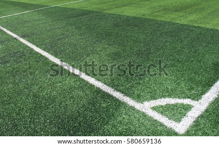 Soft focused picture of  The corner of Football field  or soccer field covered with artificial grass
