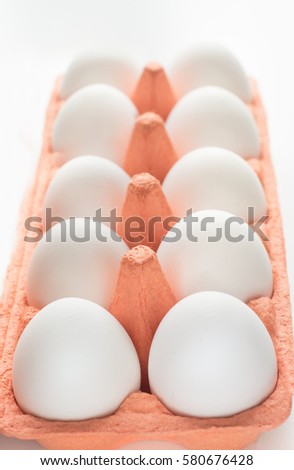 Orange carton of organic eggs. Selective focus.