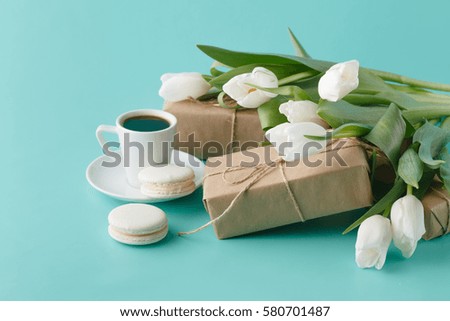 Breakfast with coffee cup and white tulips on plain background