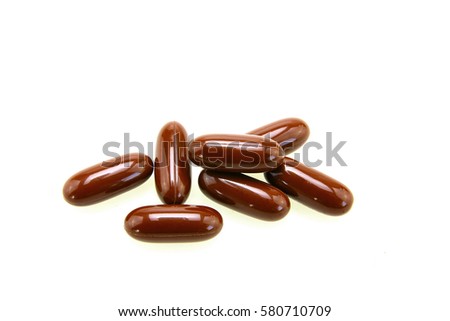 Brown pills isolated on white background Royalty-Free Stock Photo #580710709