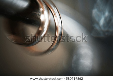 Blurred picture of wedding rings made of yellow and white gold