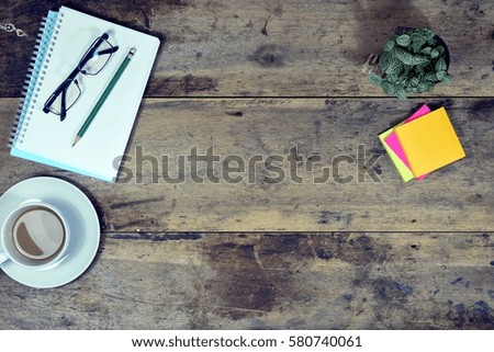 Office stuff and it gadgets display on top view business desk with copy space at text of picture. Creative table, modern project. Business empty vintage is background. Dark tone filter effects.