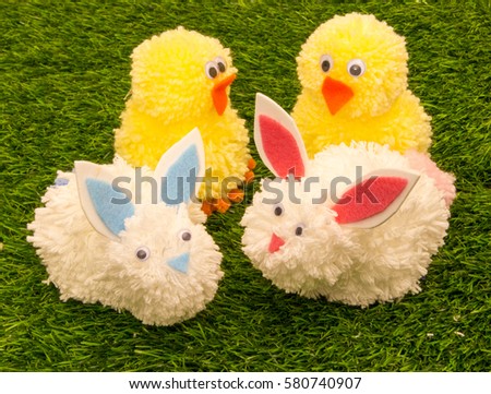 Cute Easter Chicks and Easter Bunnies Made with Pom Poms.  Royalty-Free Stock Photo #580740907