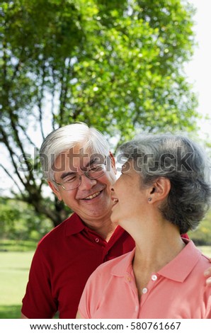 Mature couple, looking at each other, smiling
