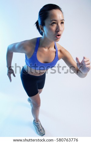 Woman in running position, high angle view