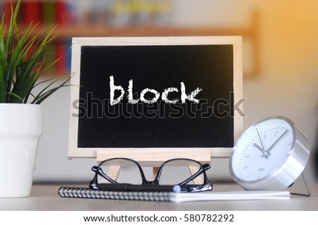 concept of coffee cup with stand board on blurred modern office background with BLOCK words. tone image