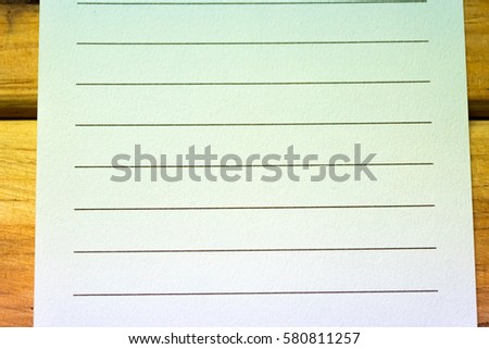 Rumpled lined sheet of paper isolated on white background. Old vintage retro paper.
