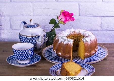 Exposition of apple pie cup of tea and kettle on wooden table and white brick background, Vintage Russian porcelain teacup and kettle, beautiful rose. 