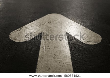 white arrow on black background asphalt