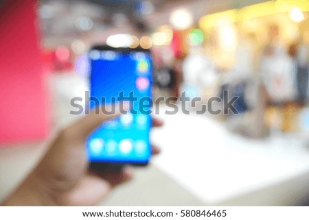 Picture blurred  for background abstract and can be illustration to article of people use phone in mall