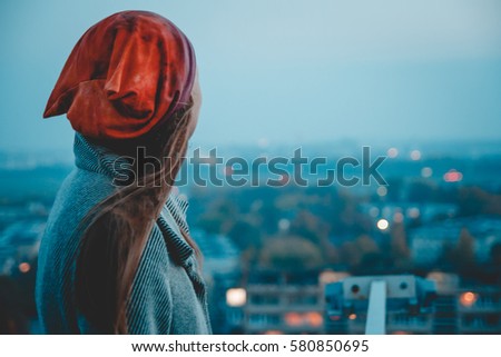 Back view of young girl on roof , city view. Freedom concept. Royalty-Free Stock Photo #580850695