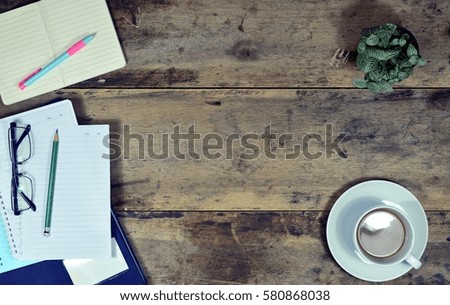 Office stuff and it gadgets display on top view business desk with copy space at text of picture. Creative table, modern project. Business empty vintage is background. Dark tone.