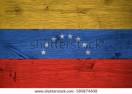Venezuela national flag painted on old oak wood. Painting is colorful on planks of old train carriage.