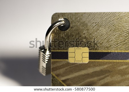 Gold credit card with small hanging padlock closeup