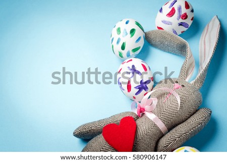 Easter bunny on a blue background. Rabbit. Easter ideas. Easter eggs. Space for text. Happy easter.
