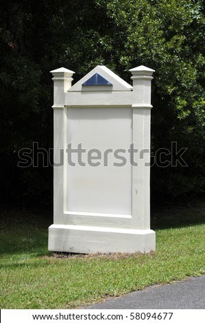 An outdoor white wooden sign that is empty.