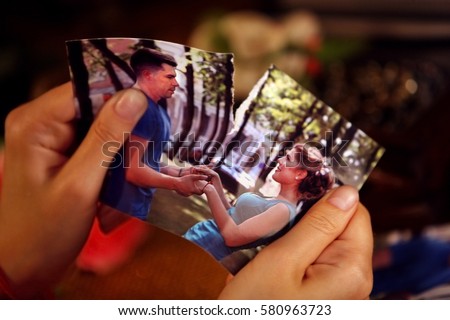Broken heart woman. Couple break up. Woman and man quarrel. Close up of female hands tearing family pictures. Royalty-Free Stock Photo #580963723