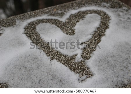 The shape of heart on the snow. Close up shot