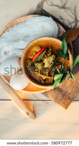Thai traditional food style Thai vermicelli eaten with green curry chicken hot and spicy(Kanom jean keawwhan kai) on wooden background wallpaper focus one point shallow with depth of field