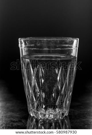 water on a glass on dark background. Black and white photo.
