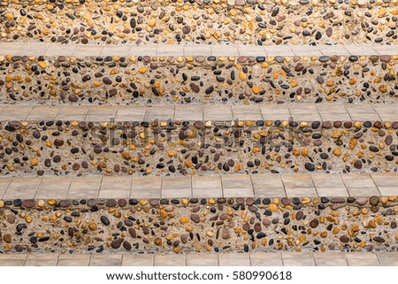colorful stair of rock decorate on cement wall for interior or exterior design background. 