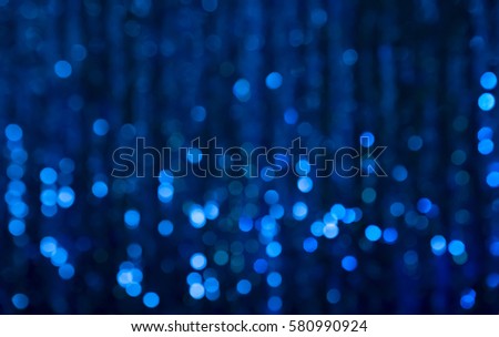 Navy Blue Festive Christmas Beautiful abstract Background with bokeh lights. Holiday Backdrop with copy space. Glitter light spots on Dark background, defocused. Horizontal Wallpaper