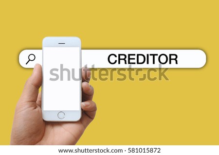Isolated male hand holding a white screen smartphone with CREDITOR words. copy space