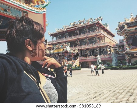 Woman taking a selfie at chinese temple