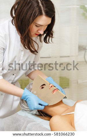 Prepare the girl's face to the microcurrent therapy. Apparatus cosmetology. Cosmetic procedures. Spa.