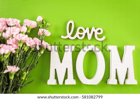 Decorations for Mother's Day on a  wood board.