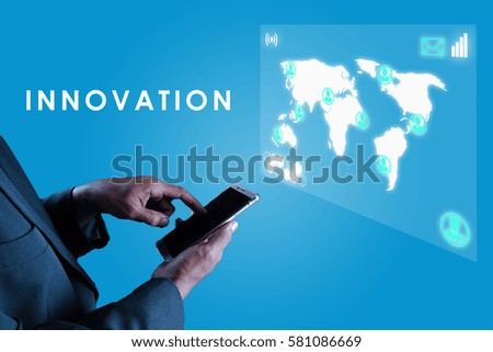 a business man touching his smart phone and an imaginary screen in front him with text INNOVATION