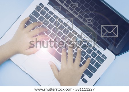 Hand typing at keyboard with flare effect. Business, finance, networking, communication concept