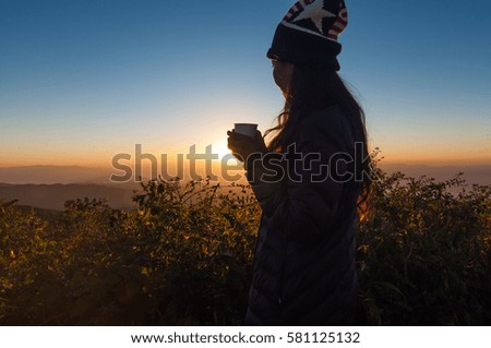Girl enjoy for drink coffee and seeing sunrise at Doi Pha Hom Pok