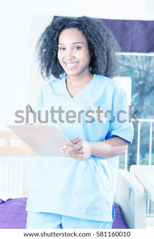 Nurse writing medical details in hospital paper.
