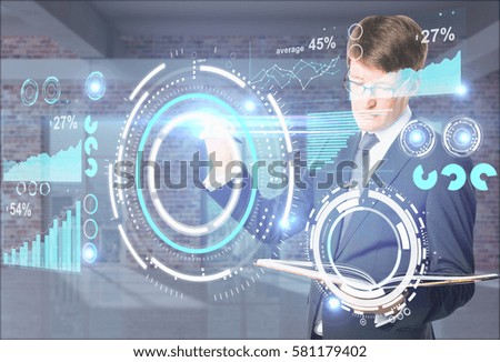 Attractive european businessman with open notepad drawing abstract  pattern and charts. Virtual business technology concept
