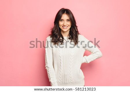 Young cheerful girl wearing winter cozy sweater Royalty-Free Stock Photo #581213023