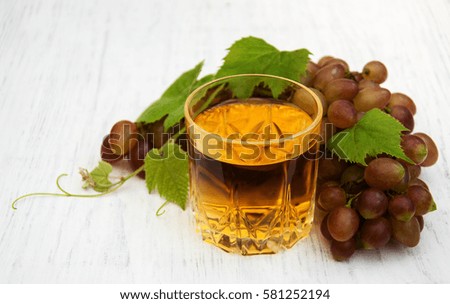 Glass with wine  on a wooden background
