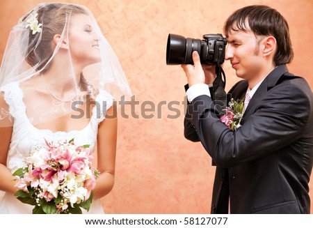 Husband taking picture of his wife on wedding.