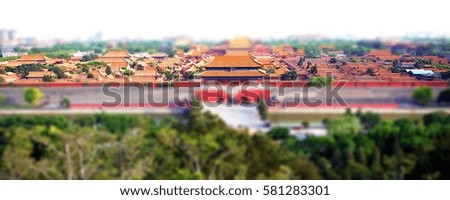 Blurred full and top view photo of the Forbidden City from Jingshan park's viewpoint in Beijing, China.