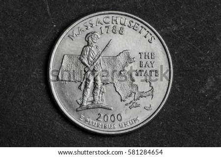Close up of Massachusetts quarter dollar coin on black background - business concept