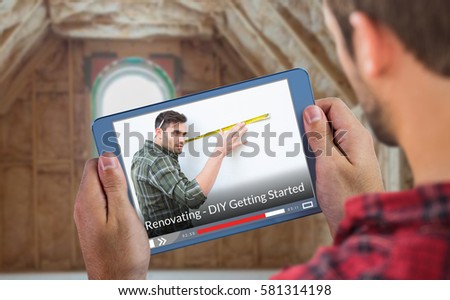 Man using tablet against cropped image of person holding tablet