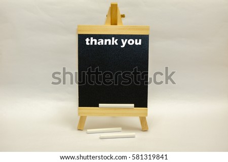 "Thank You" word written on mini chalkboard with white chalks isolated over white background