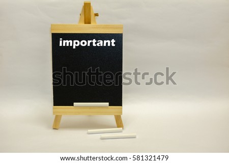 Small blackboard written "important" with white chalks isolated over white background