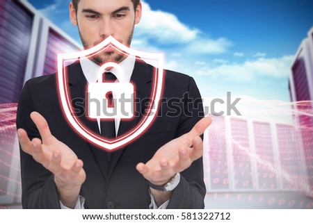 Cheerful businessman presenting with his hands against composite image of server towers