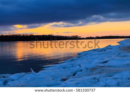 Bright sunset over the river Dnieper on winter