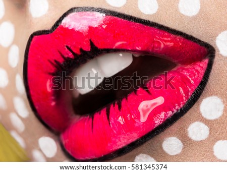 Photo of young woman with professional comic pop art make-up. Creative beauty style. Photos shot in studio. Close up lips