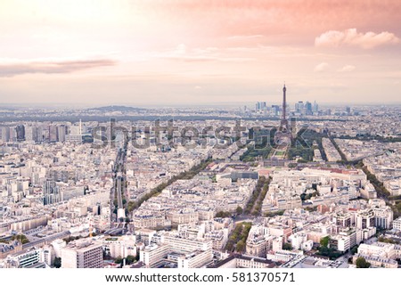 Aerial View of Paris. Champs Elysees and the Eiffel Tower view of Paris from the roof of the Montparnasse. Sunset romantic background.