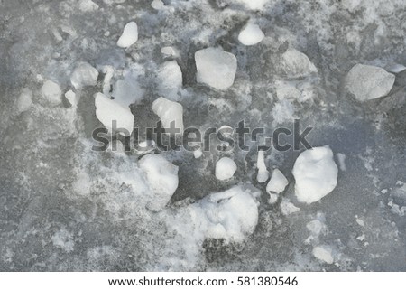 Wet, dirty snow with chunks of ice,photographed in close-up. Image of gray dark colors. You can use for the background.
