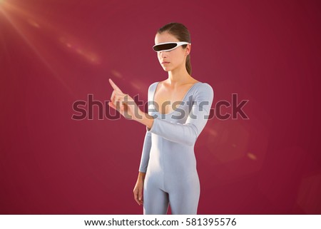 Woman pointing while using virtual video glasses against red background